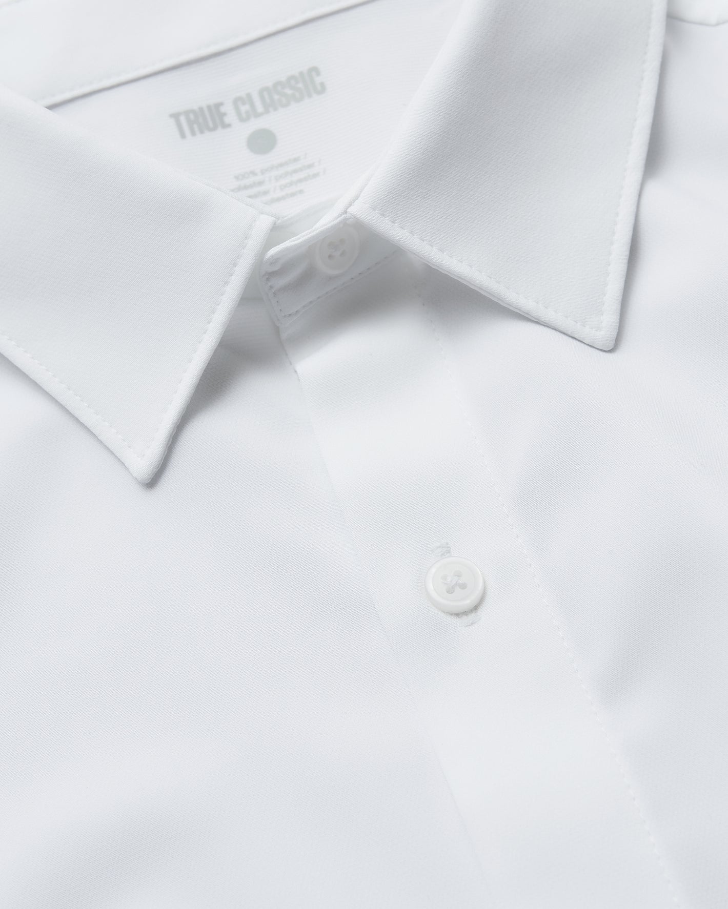 All White Short Sleeve Performance Dress Shirt close-up of collar and buttons.