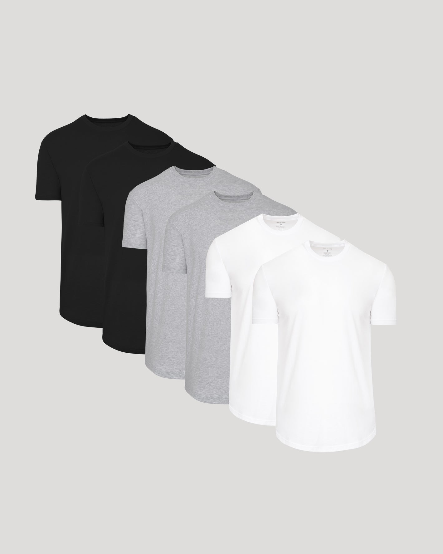 Three t-shirts in black, gray, and white on a light gray background