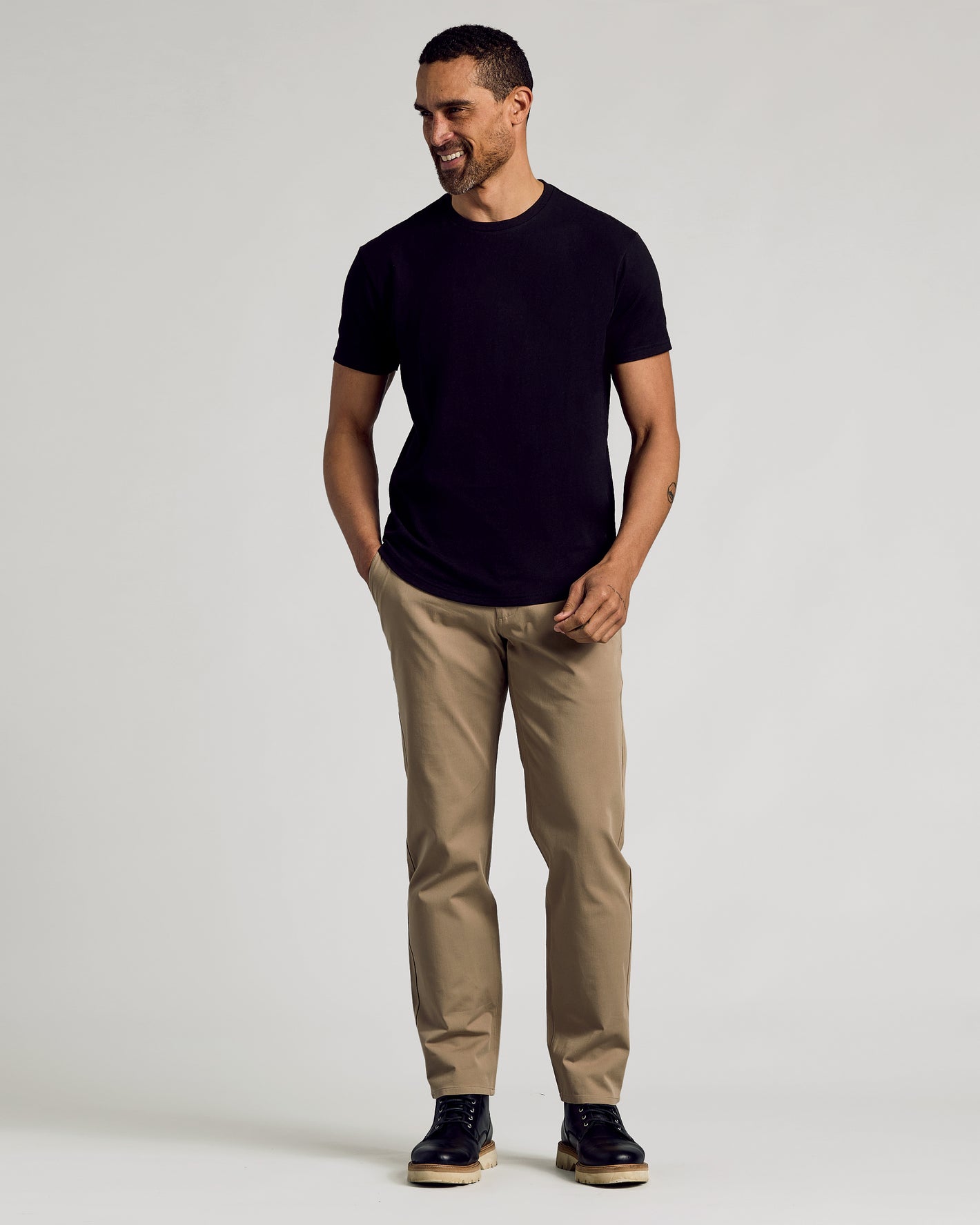 Man wearing Classic Curved Hem Crew T-shirt with khaki trousers.