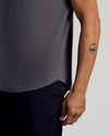 Carbon Curved Hem Classic Crew Neck, bicep-hugging fit, visible tattoos.