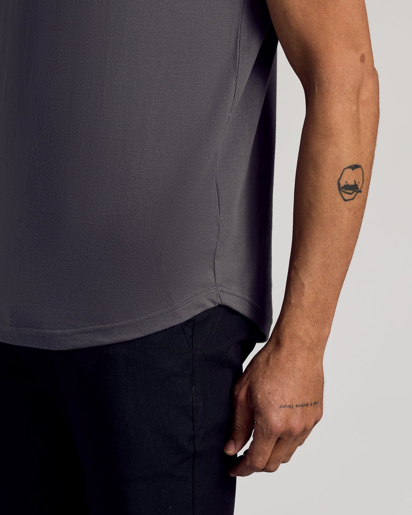 Person wearing Seasonal Classic Curved Hem Crew, showcasing fit and tattoos.