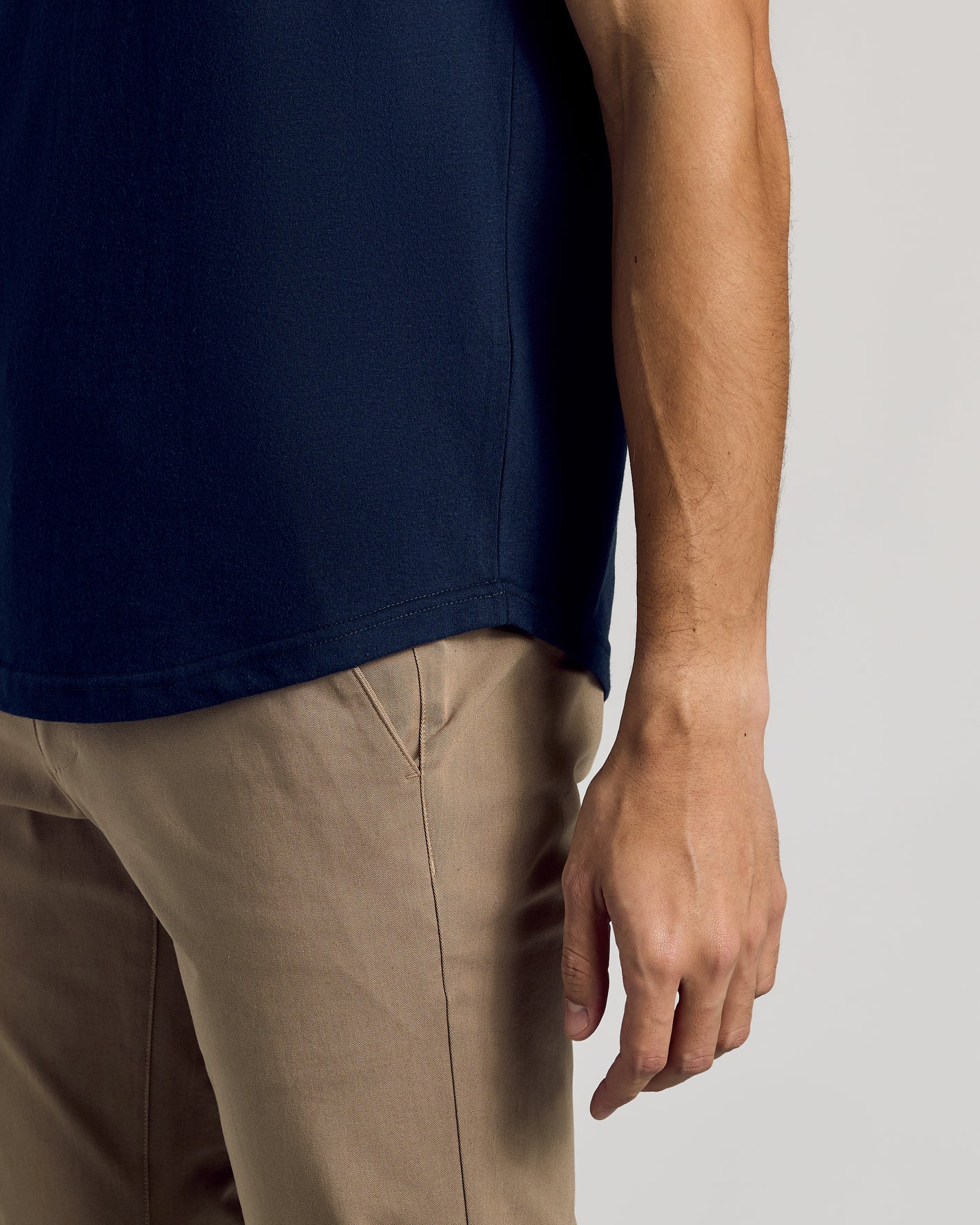 Navy Curved Hem Classic Crew Neck on person with khaki pants.