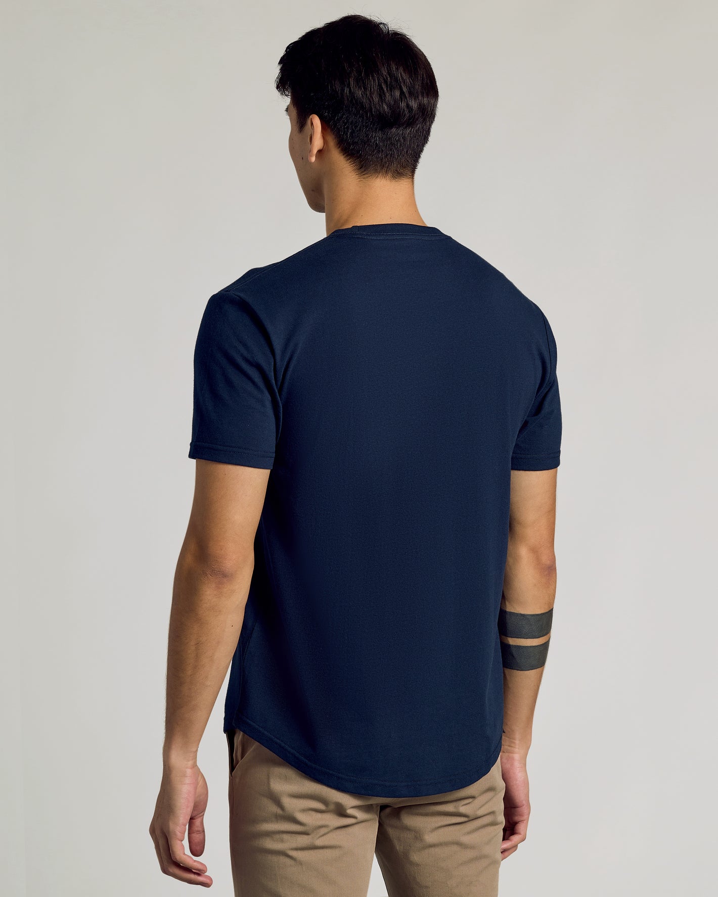 Navy Curved Hem Classic Crew Neck on person, rear view.