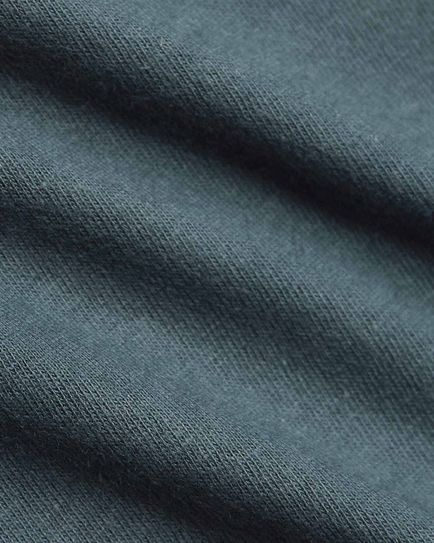Neptune Curved Hem Classic Crew Neck's fine knit texture with soft folds.