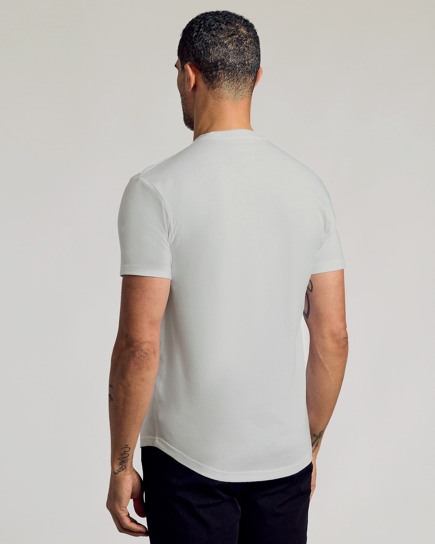 Back view of man wearing Seasonal Classic Curved Hem Crew Neck.