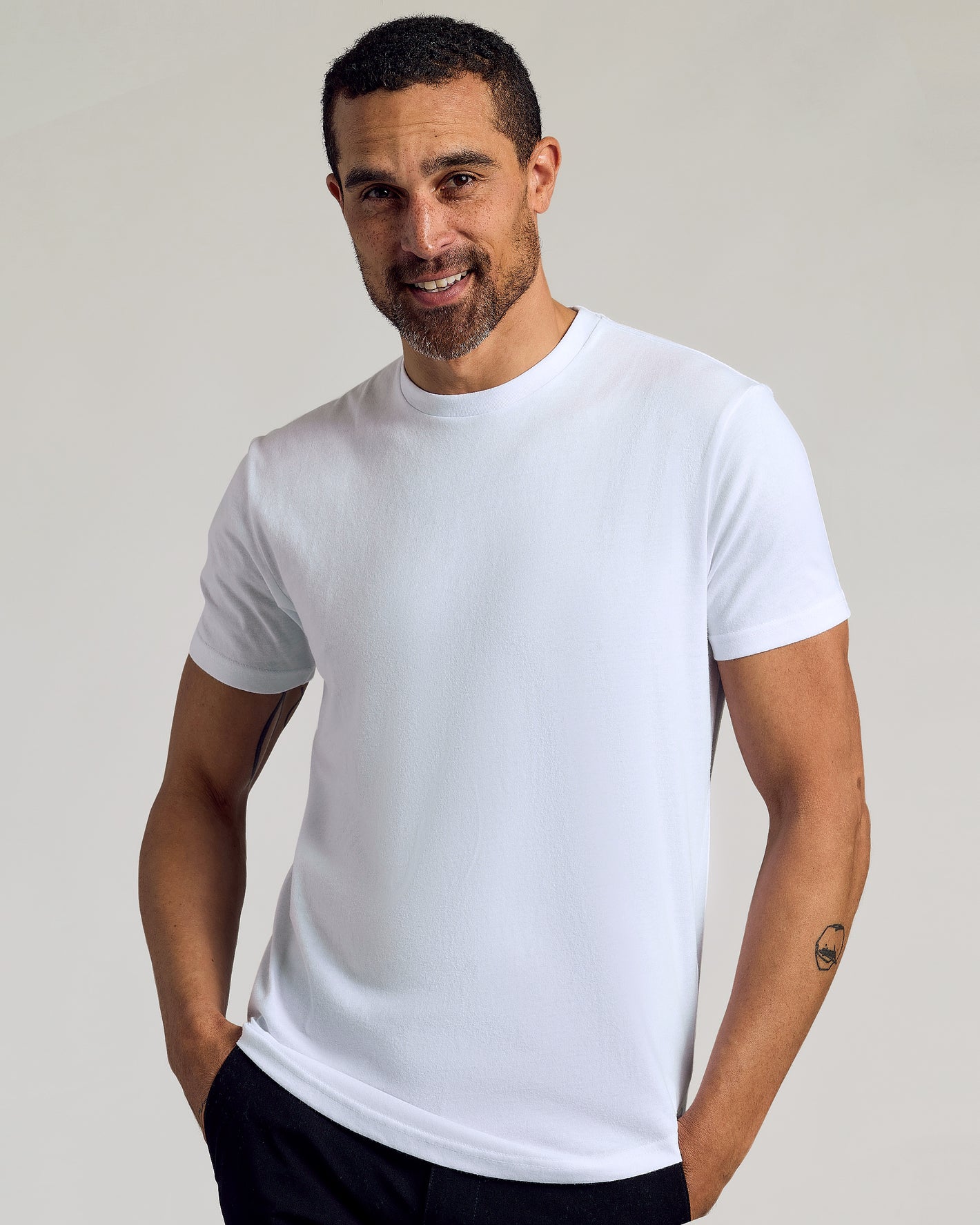Man wearing All White Curved Hem Classic Crew Neck T-shirt.