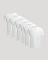 Set of six white t-shirts on a light gray background
