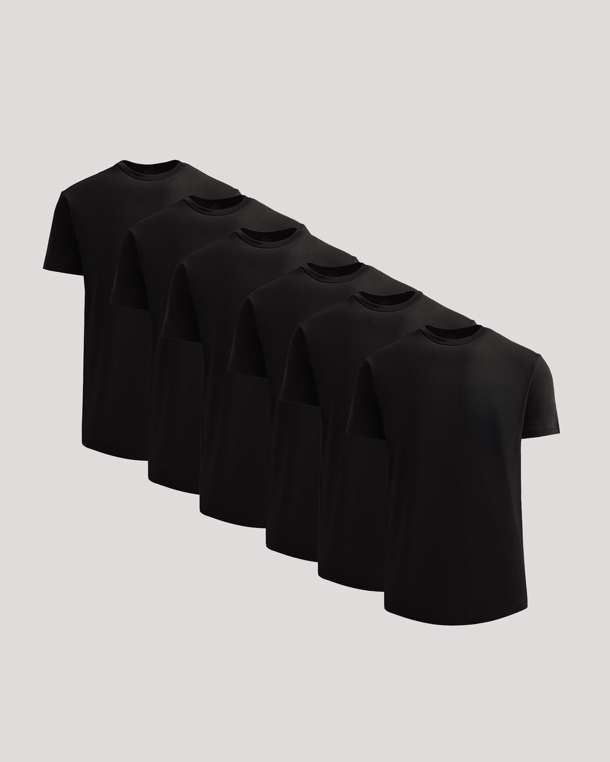 Six black crew neck t-shirts arranged in a diagonal row displaying the True Classic Men's Heavyweight Curved Hem Crew – Premium Heavyweight Cotton Blend, Modern Athletic Fit, Structured Everyday T-Shirt in men's basics style.