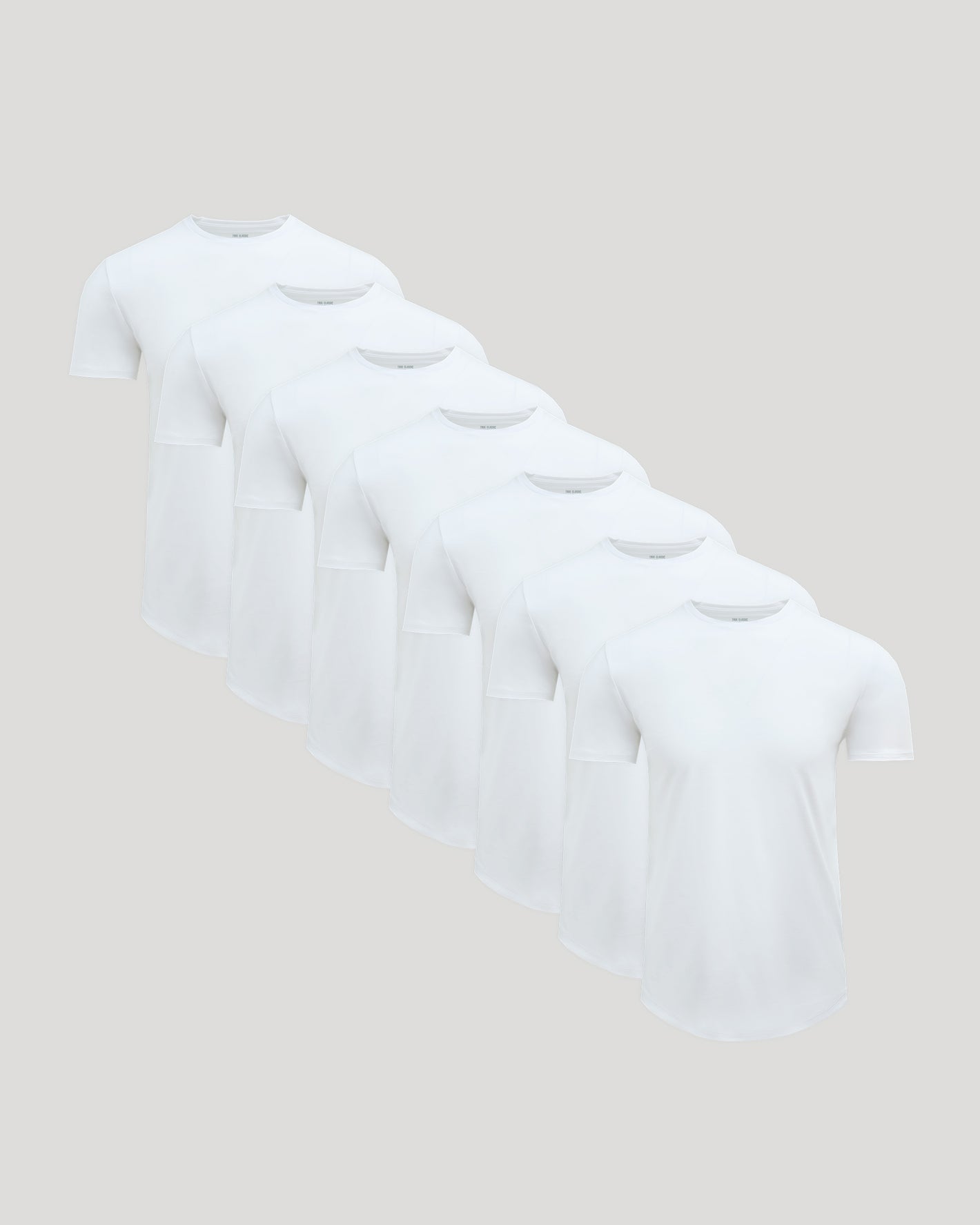 True Classic Men’s Pima Cotton Blend Curved Hem Crew T-shirts arranged stylishly.