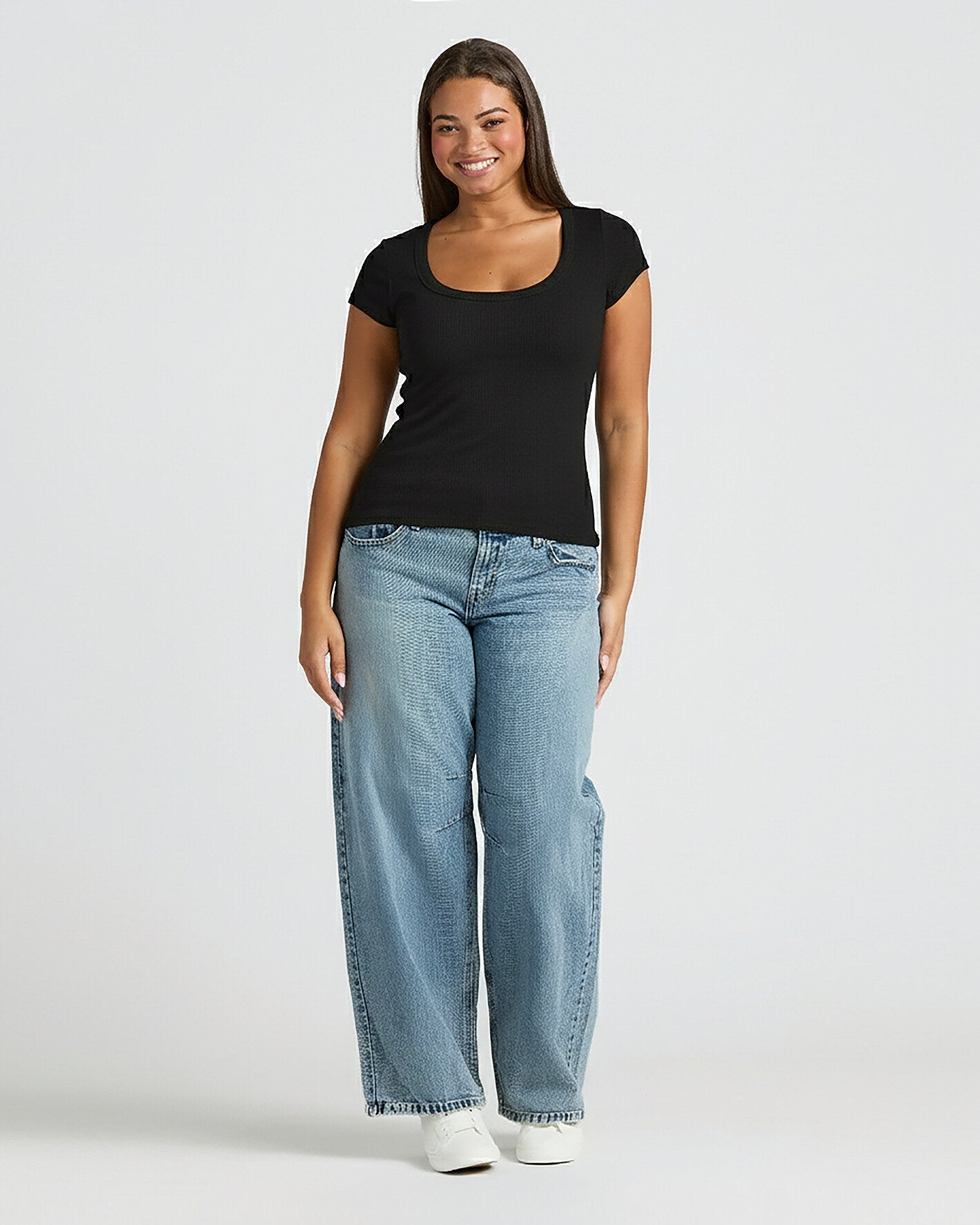 Womens Black Ribbed U-Neck Tee worn with jeans and white shoes.