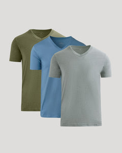 True ClassicThree short-sleeve V-neck t-shirts in olive green, light blue, and heather gray, arranged in a layered overlapping display on a light gray background.