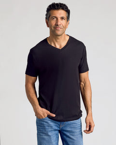 True ClassicMan in All Black Classic V-Neck T-Shirt and blue jeans.