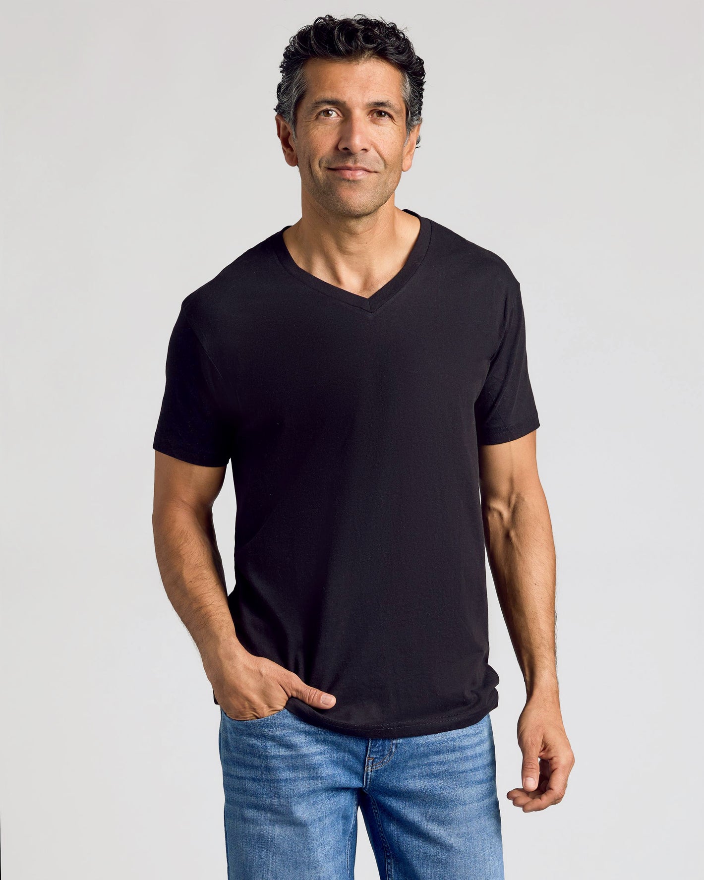 Man in Staple Classic V-Neck T-Shirt and blue jeans.