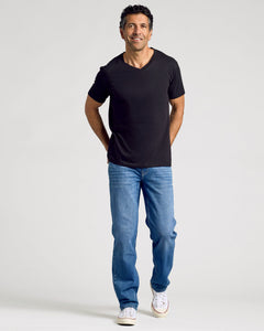 True ClassicMan wearing All Black Classic V-Neck T-shirt, smiling casually.