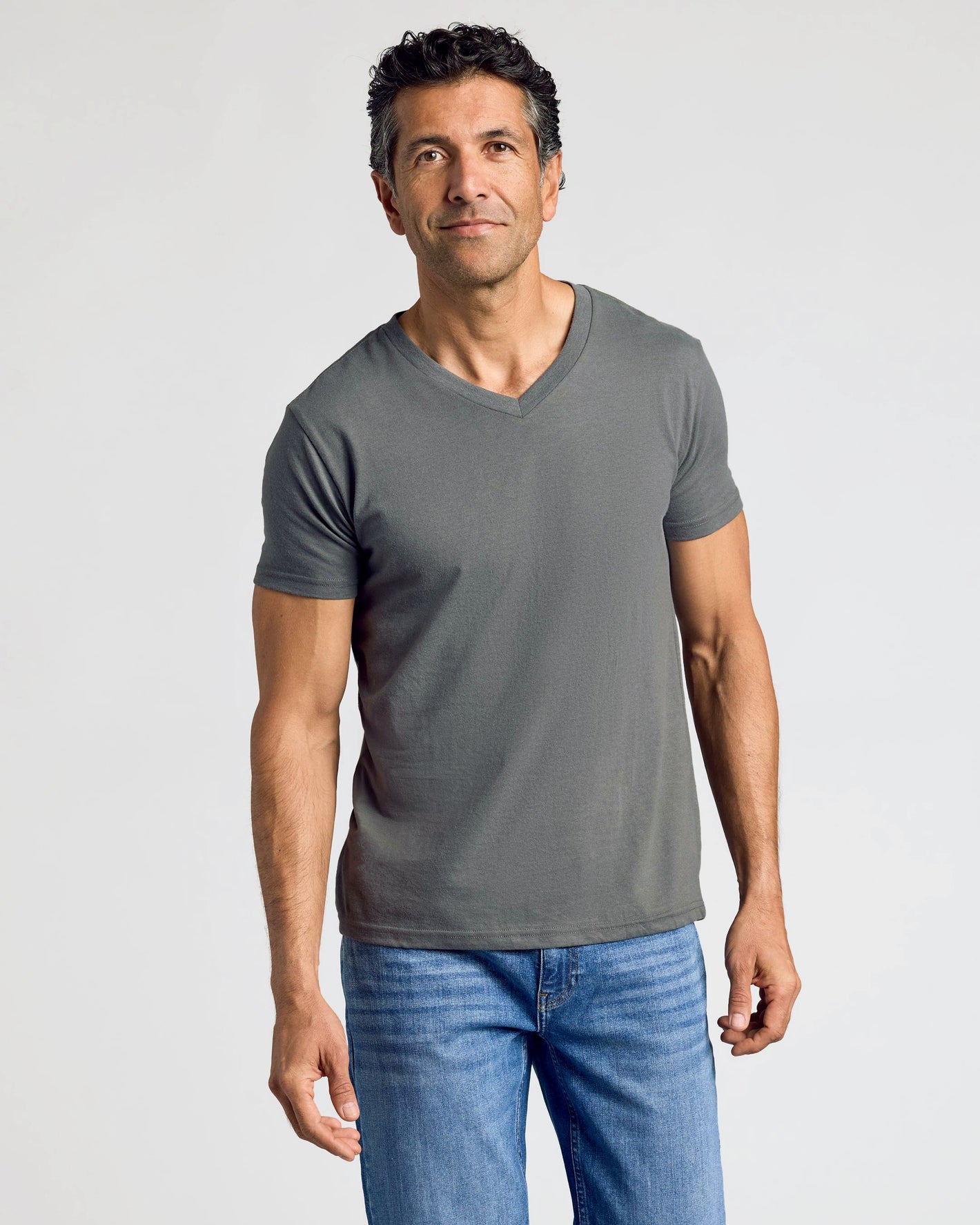 Man wearing Staple Classic V-Neck 10-Pack, charcoal-gray, relaxed posture.