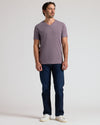 Man in Dark Heather Amethyst Classic V-Neck, jeans, and sneakers.