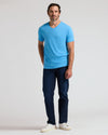 Man in Dark Heather Bahama Blue Classic V-Neck T-shirt and jeans.