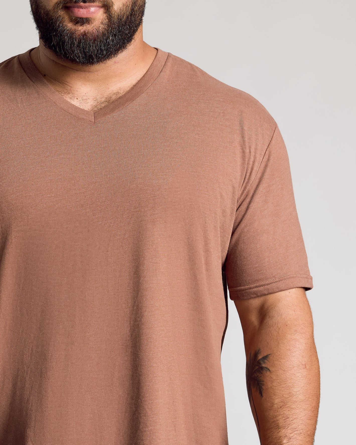 Bearded man in Dark Heather Sepia Classic V-Neck.