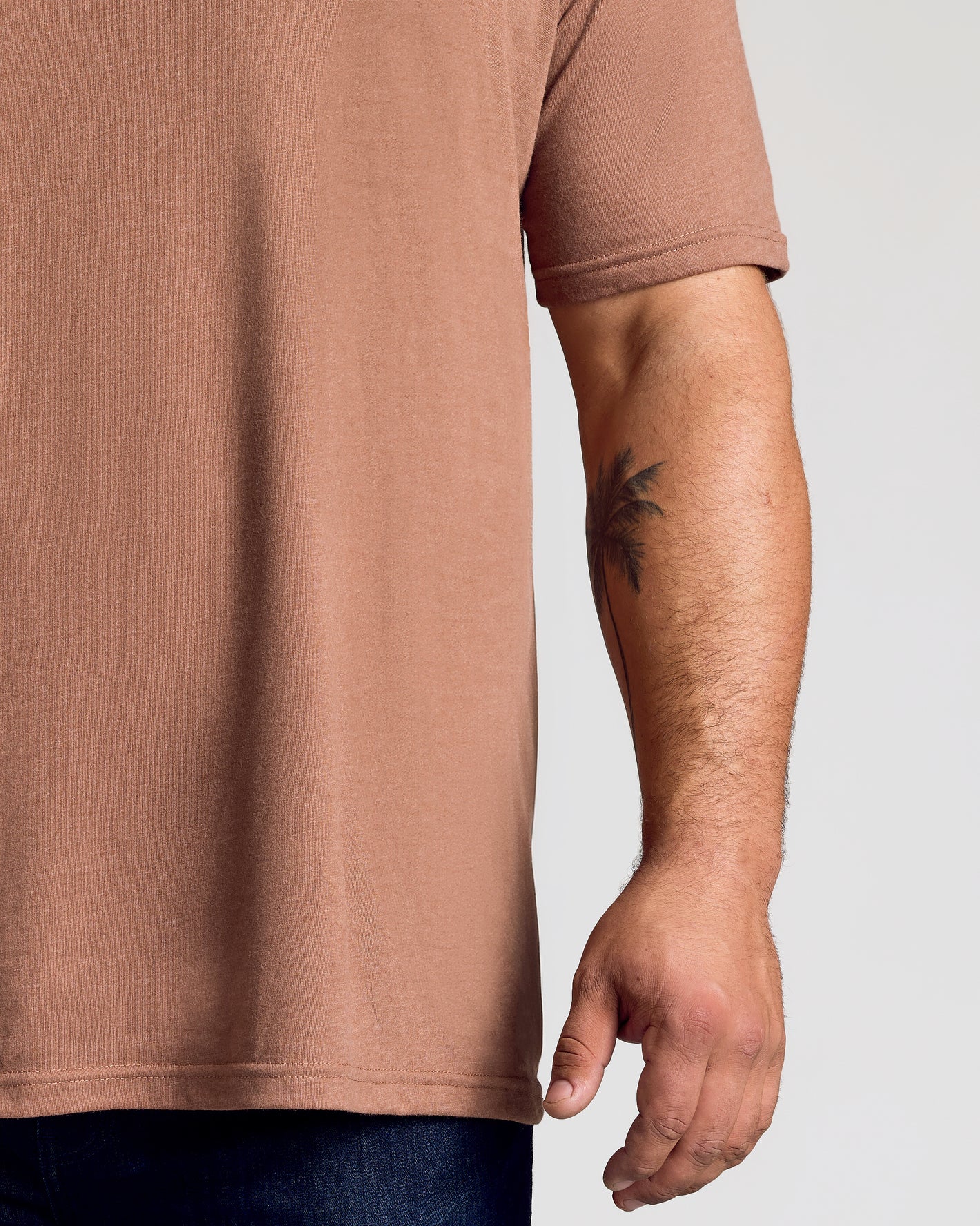 Dark Heather Sepia Classic V-Neck showcased on model's right side, tattoo visible.