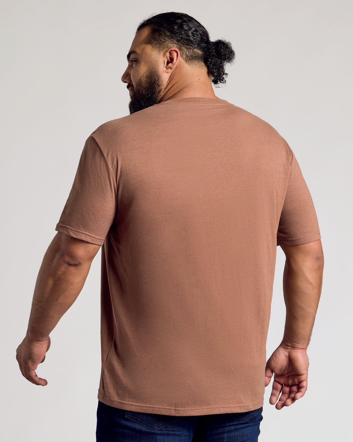 Man wearing Dark Heather Sepia Classic V-Neck and dark jeans, back view.