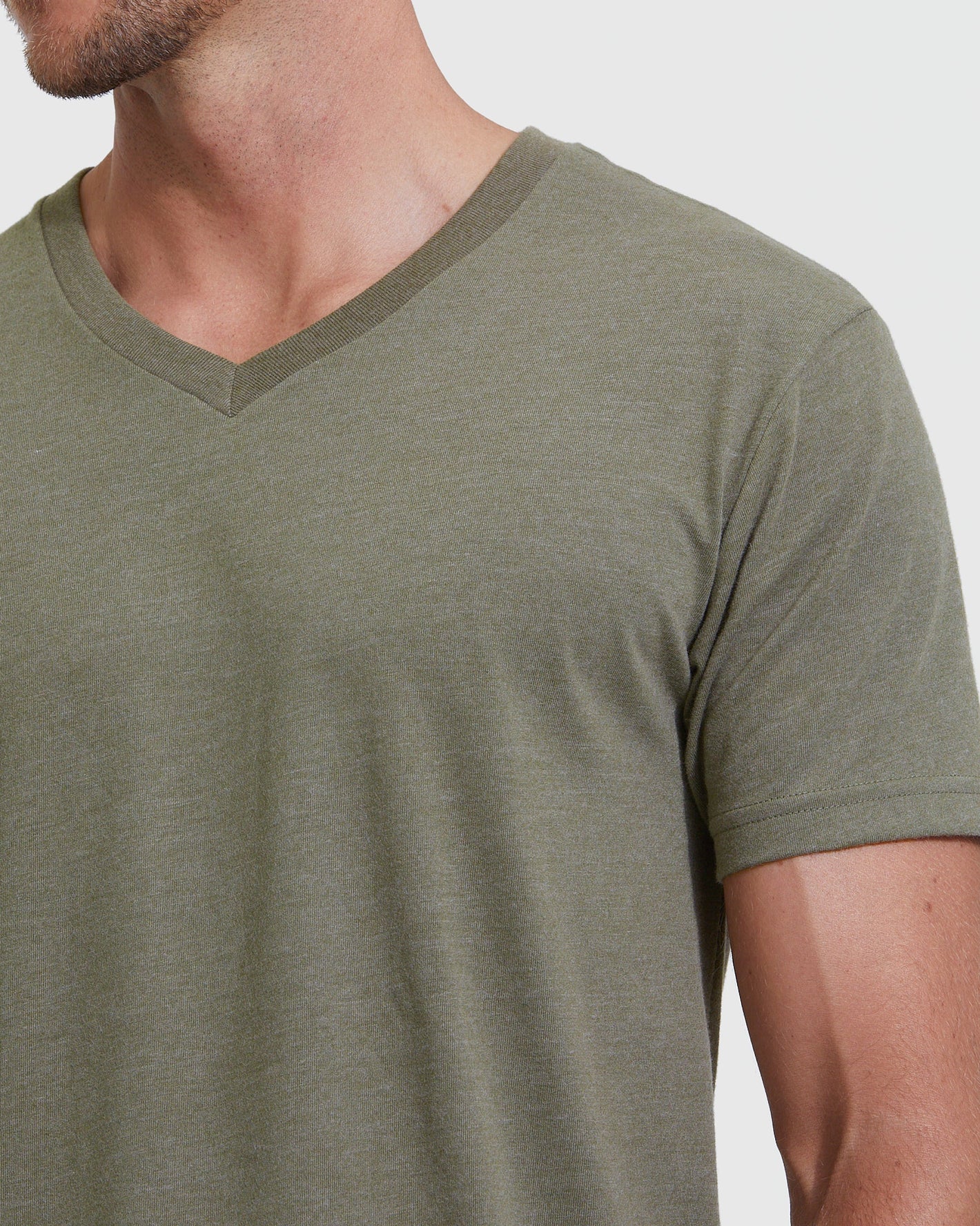 Man wearing Heather Military Green Classic V-Neck T-shirt, showing neckline and sleeves.