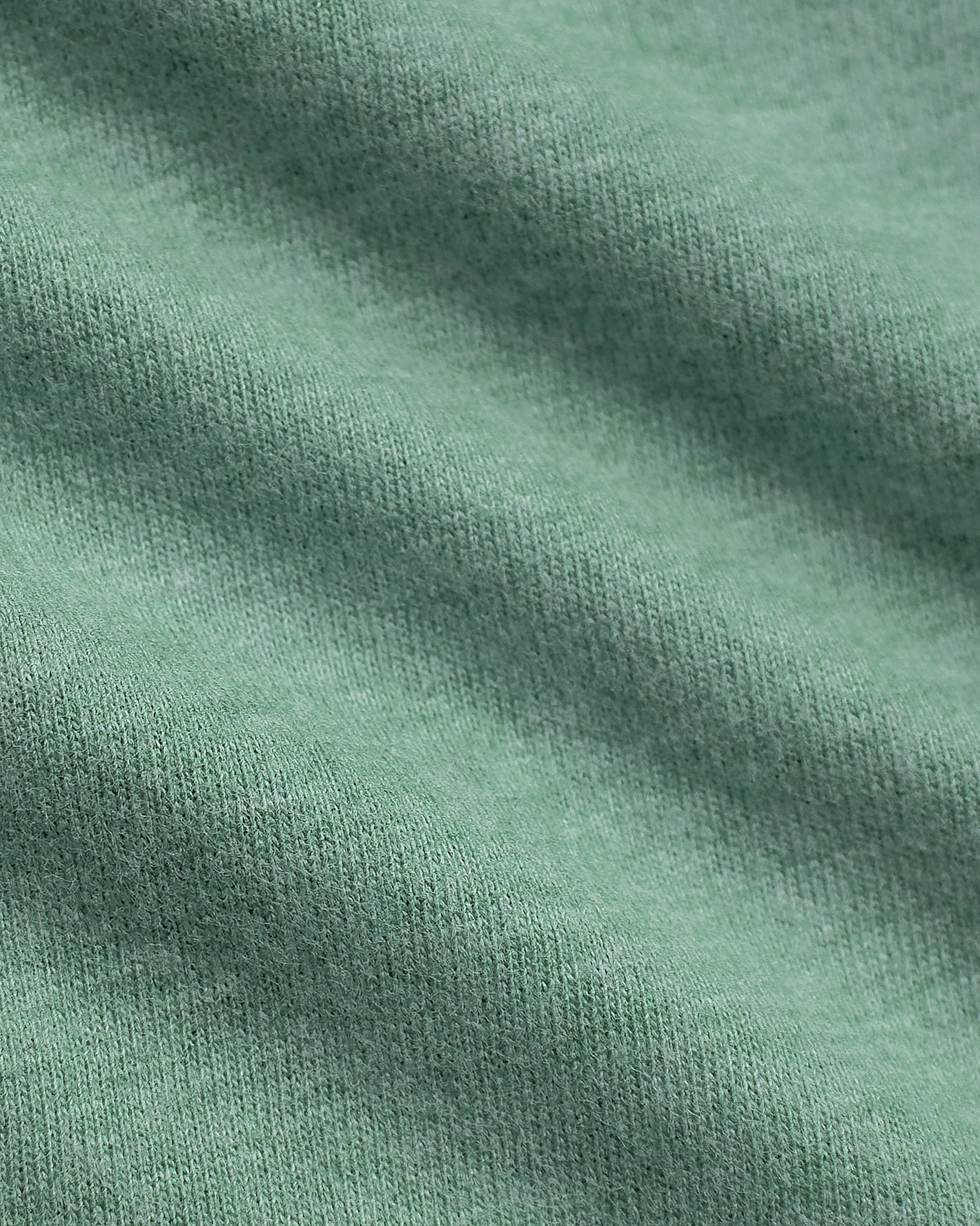 Light Heather Greenery Classic V-Neck, close-up of soft green knitted fabric.