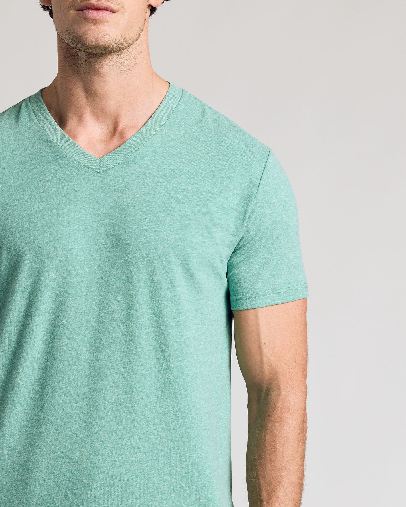 Light Heather Greenery Classic V-Neck on a man’s upper body.