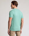 Man in Light Heather Greenery Classic V-Neck, showcasing back fit.