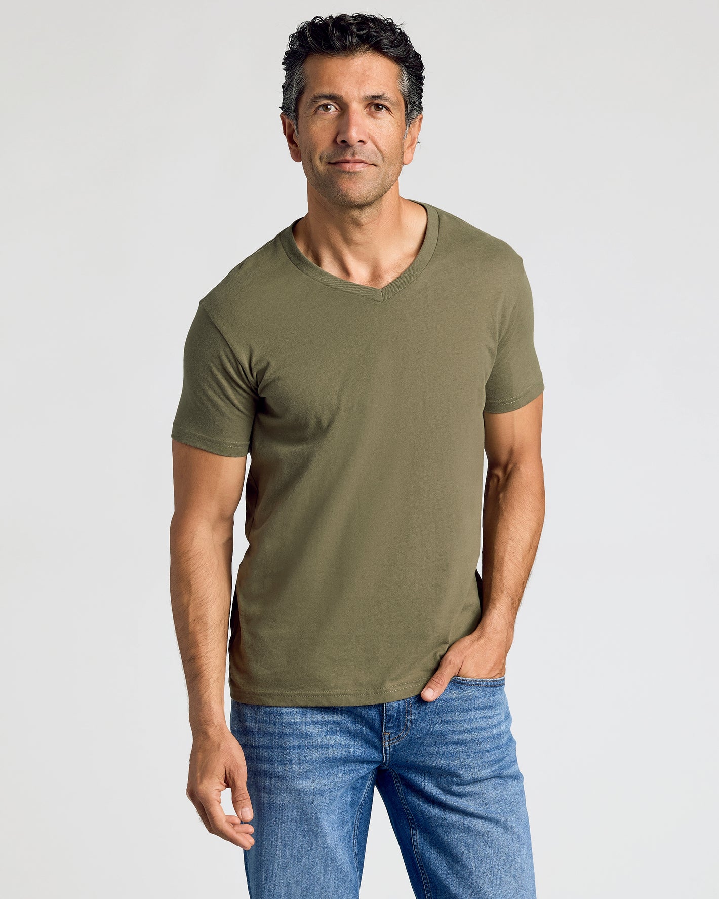 Man wearing olive-green V-neck from Staple Classic V-Neck 10-Pack.