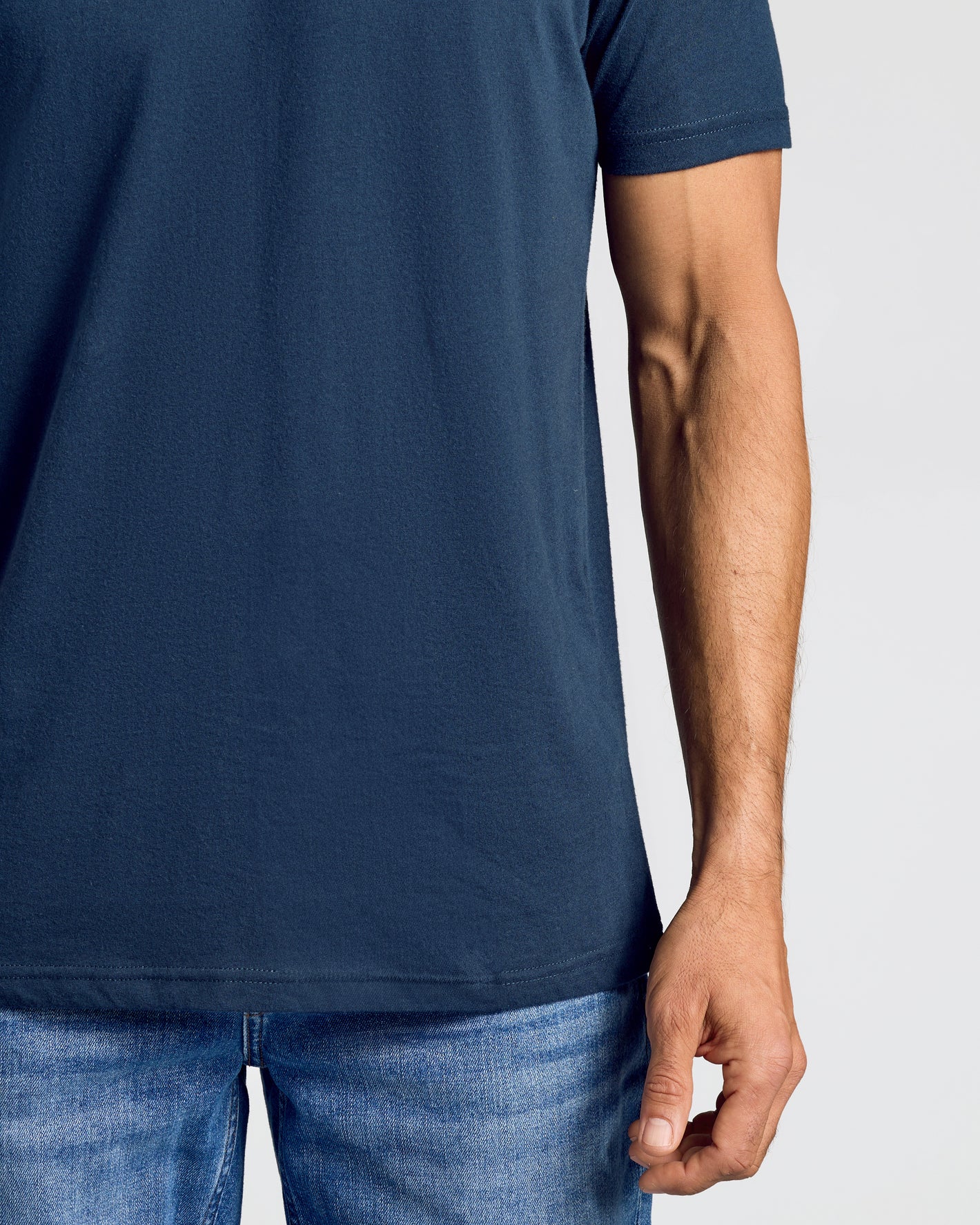 Person wearing dark-blue Staple Classic V-Neck T-shirt with blue jeans.