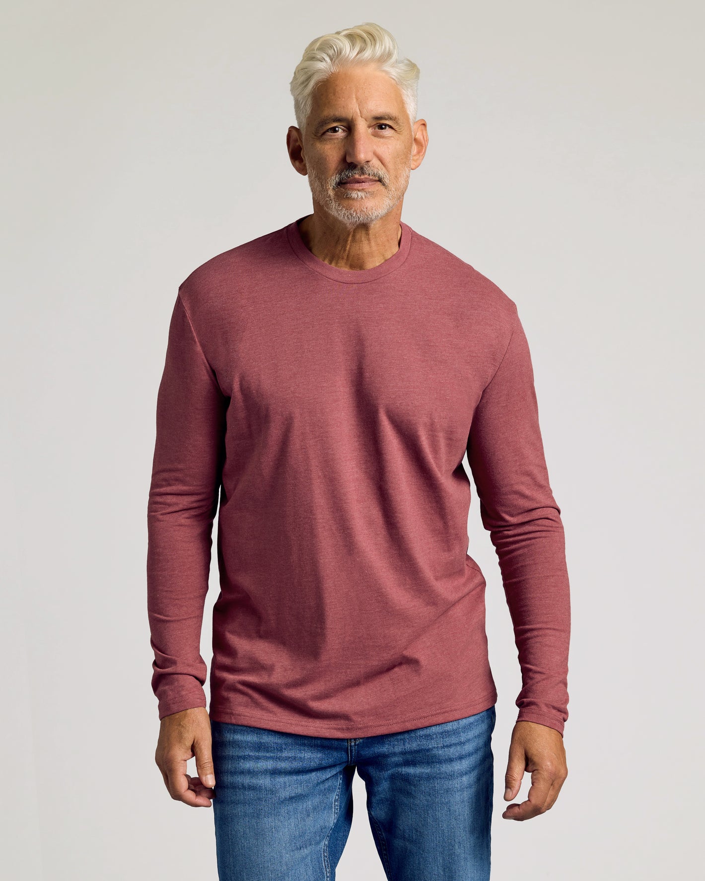 Man wearing Dark Heather Rustic Apple Classic Long Sleeve Crew Neck.