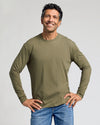 Man in olive Classic Long Sleeve Crew Neck, hands on hips.
