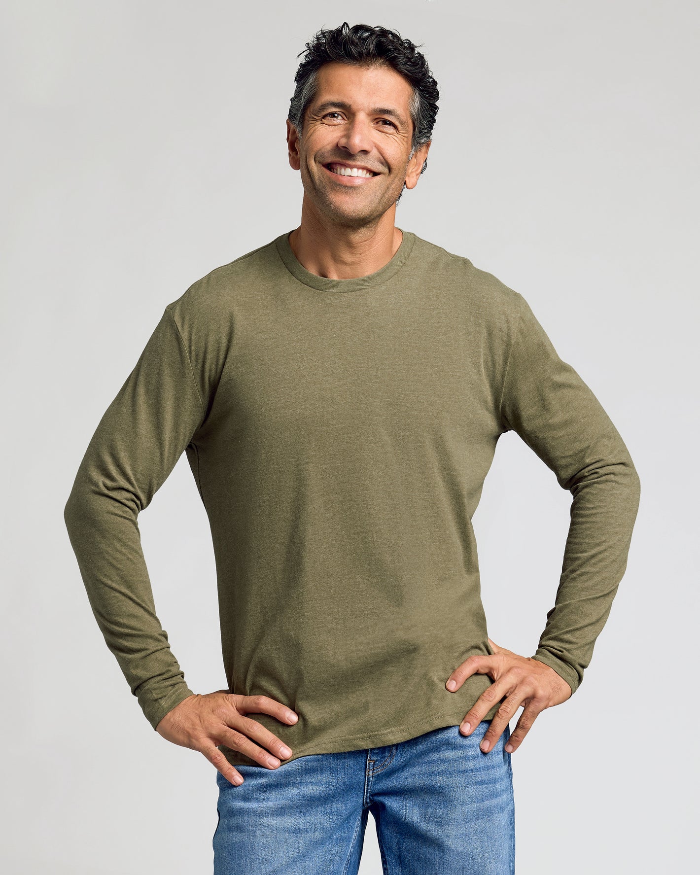 Man in olive Classic Long Sleeve Crew Neck, hands on hips.