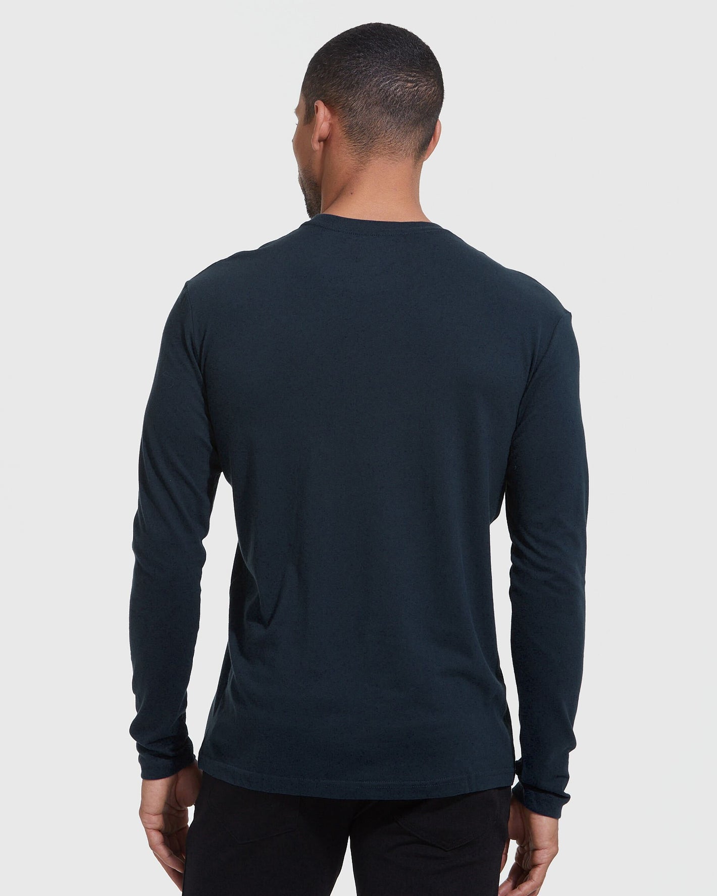 Man wearing Standard Long Sleeve Crew from 3-Pack, facing back, in navy.