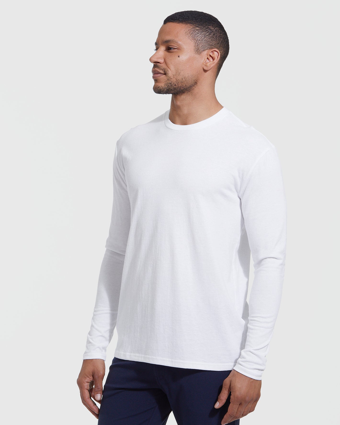 Man wearing The Versatile Crew 9-Pack white long-sleeve T-shirt.