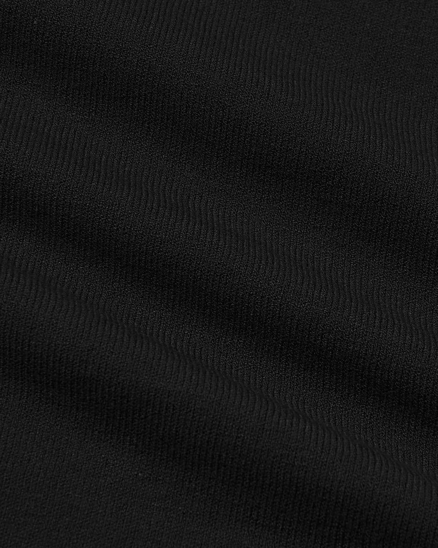 Black Dressy Crew Neck Sweater with fine knit texture and subtle folds.