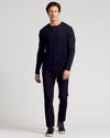 Man wearing All Black Classic Henley 6-Pack with trousers and sneakers.