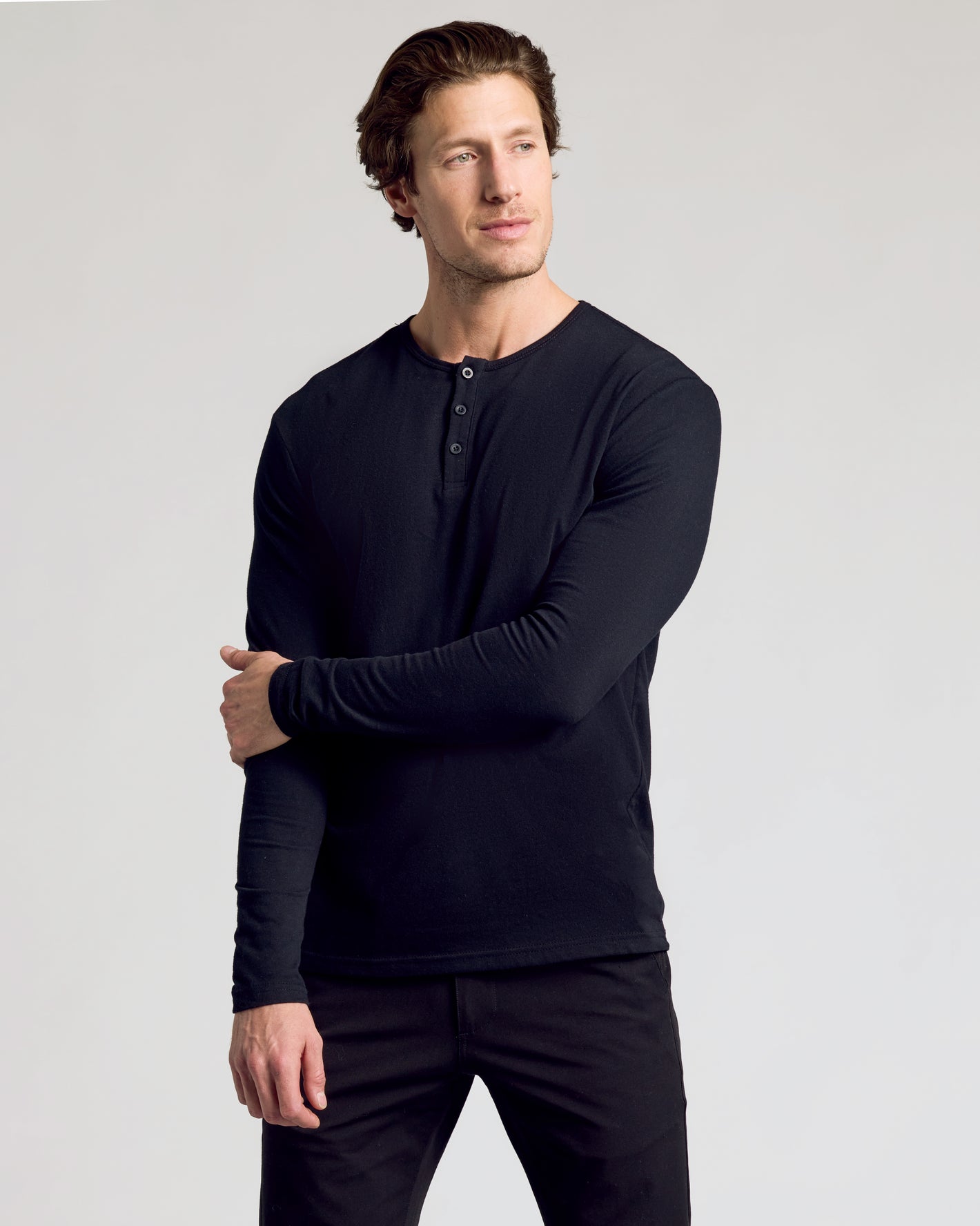 Model in All Black Classic Henley 6-Pack, stylishly paired with black pants.