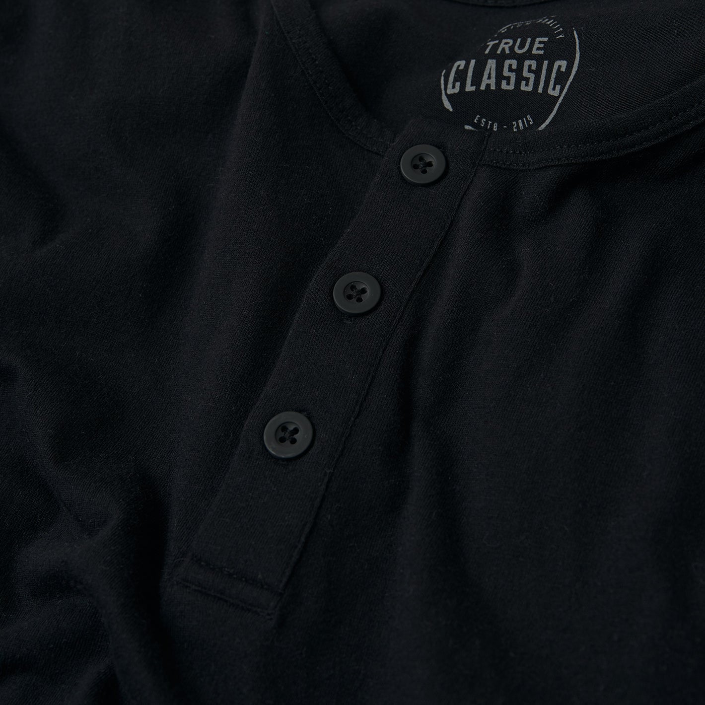 All Black Classic Henley 6-Pack, featuring soft-knit fabric and black buttons.