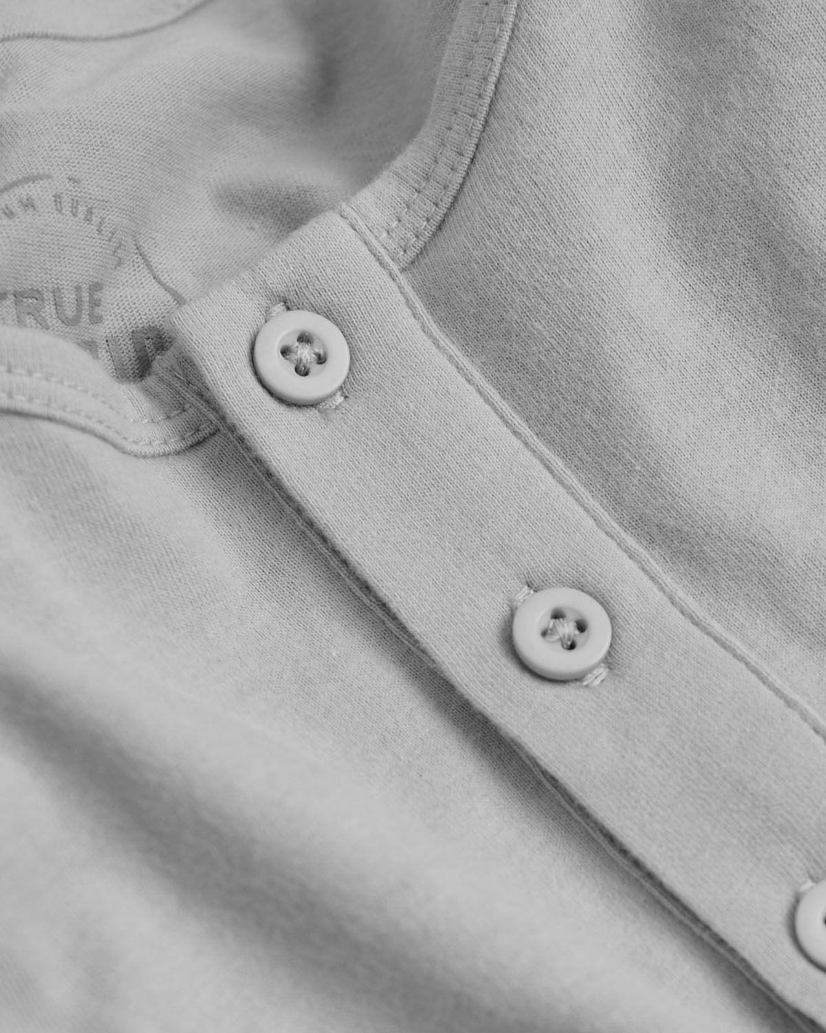 Glacier Gray Long Sleeve Henley close-up with buttons and soft jersey fabric.