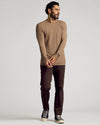 Man wearing Alpaca Waffle Long Sleeve Crew Neck, dark brown pants, navy sneakers.