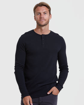 Man wearing The Staple Long Sleeve Henley 3-Pack shirt.