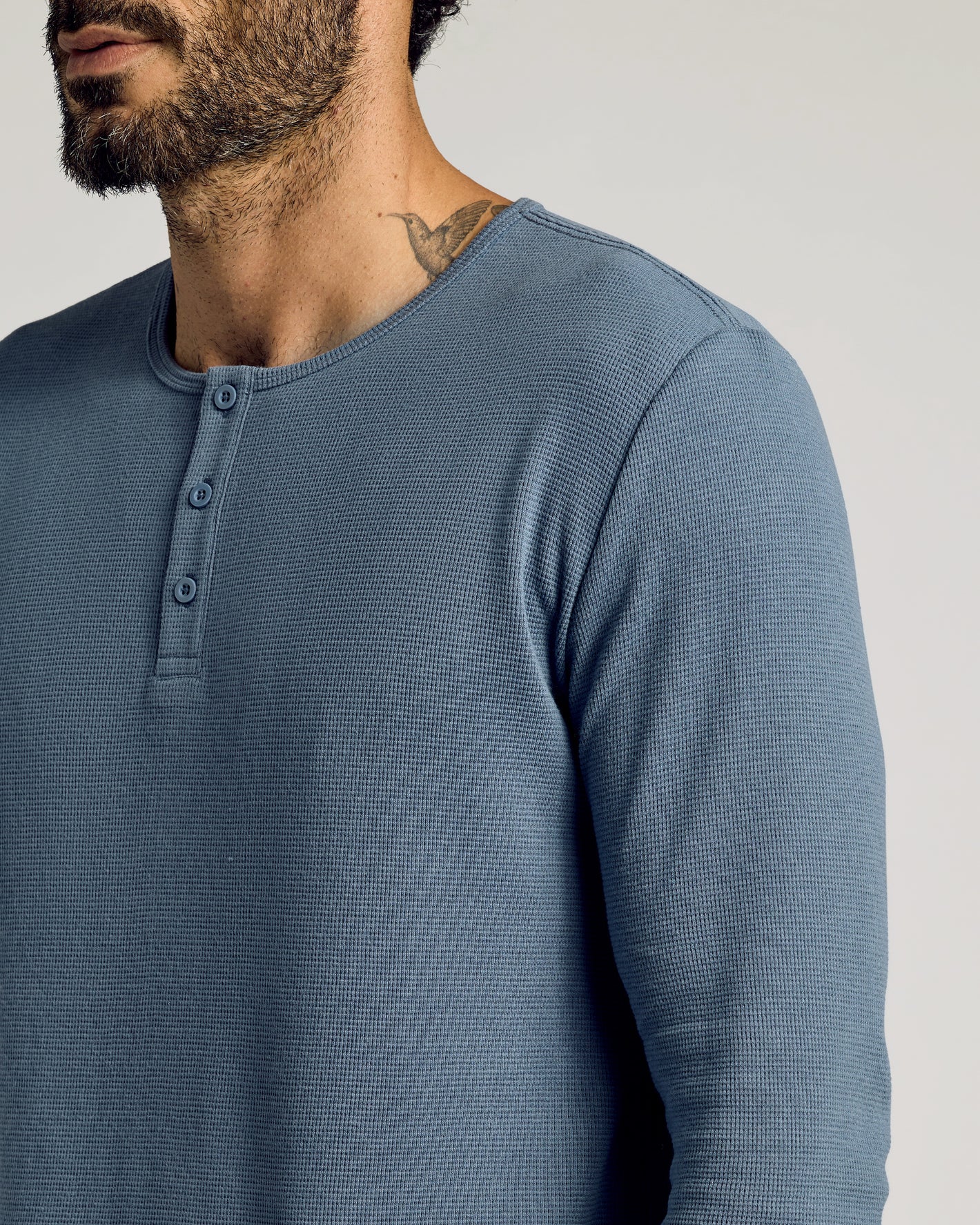 Fiord Waffle Long Sleeve Henley on bearded man with hummingbird tattoo.