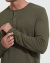 Man wearing olive Waffle Long Sleeve Henley, adjusting sleeve.