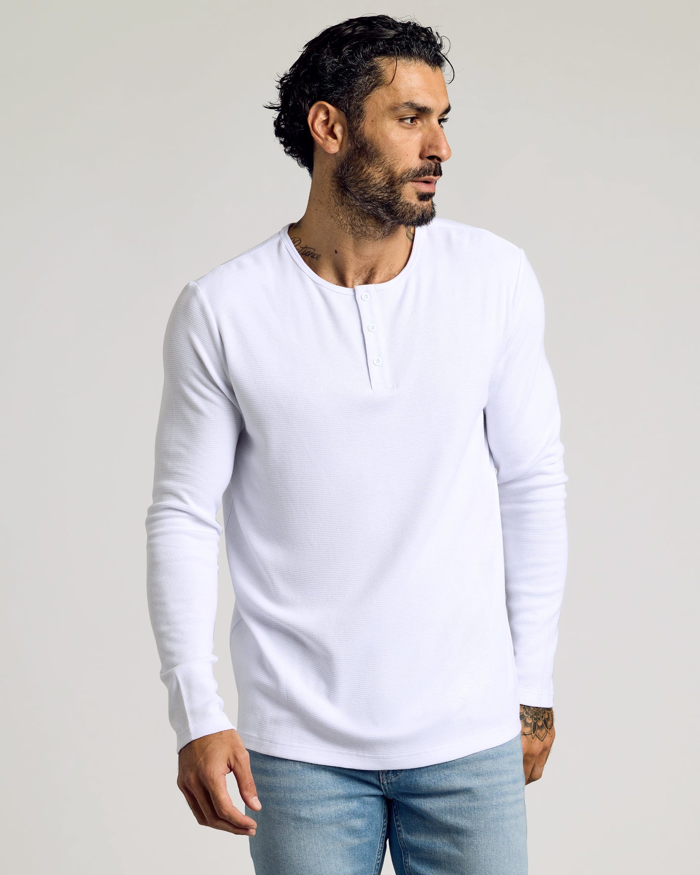 Man wearing White Waffle Long Sleeve Henley, showcasing its textured waffle-knit design.