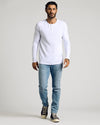 Man wearing a White Waffle Long Sleeve Henley with jeans and sneakers.