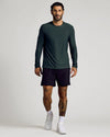 Man wearing Dark Heather Forest Active Long Sleeve Crew T-Shirt walking.