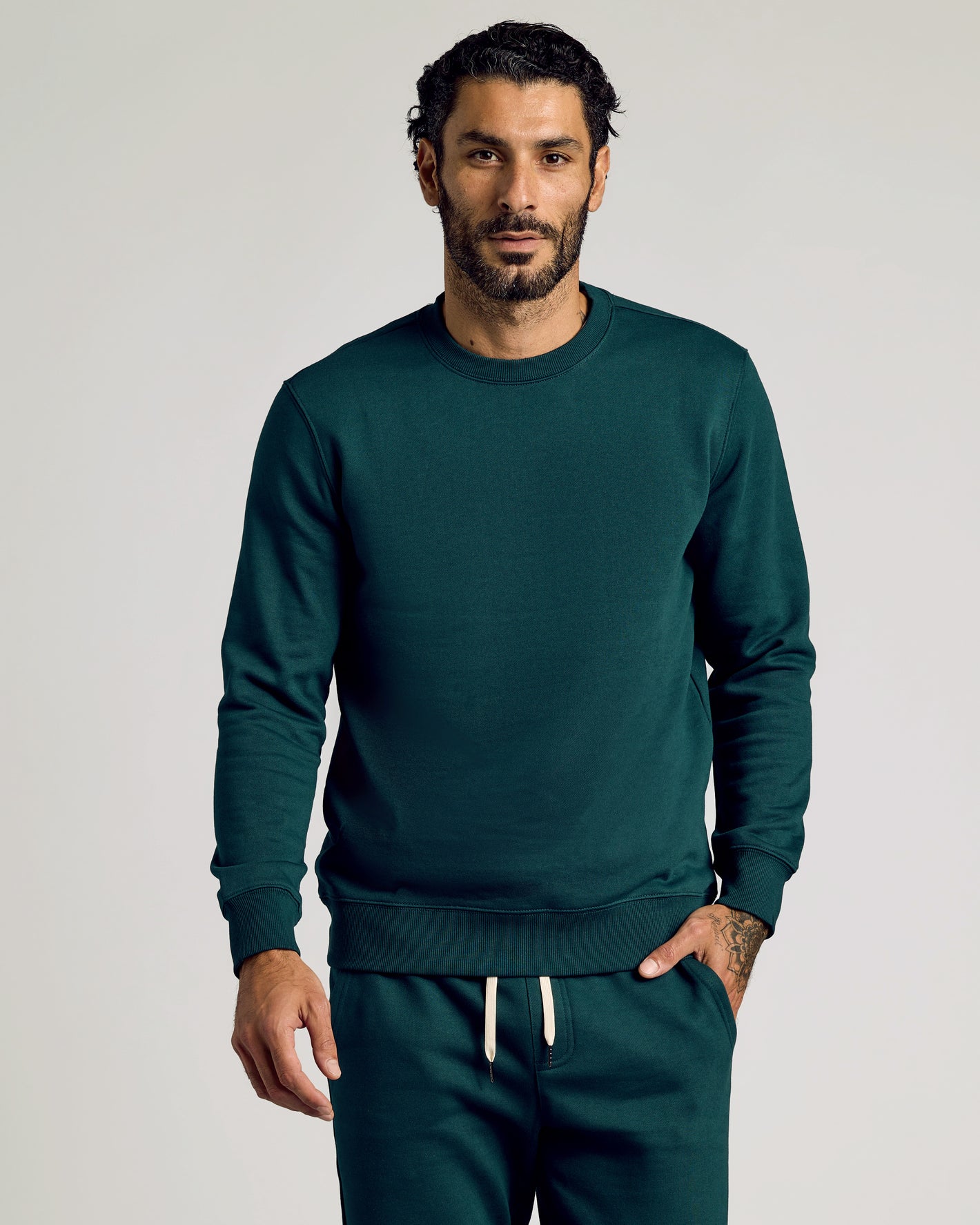 Man wearing Emerald Fleece French Terry Pullover Crew Neck Sweatshirt.