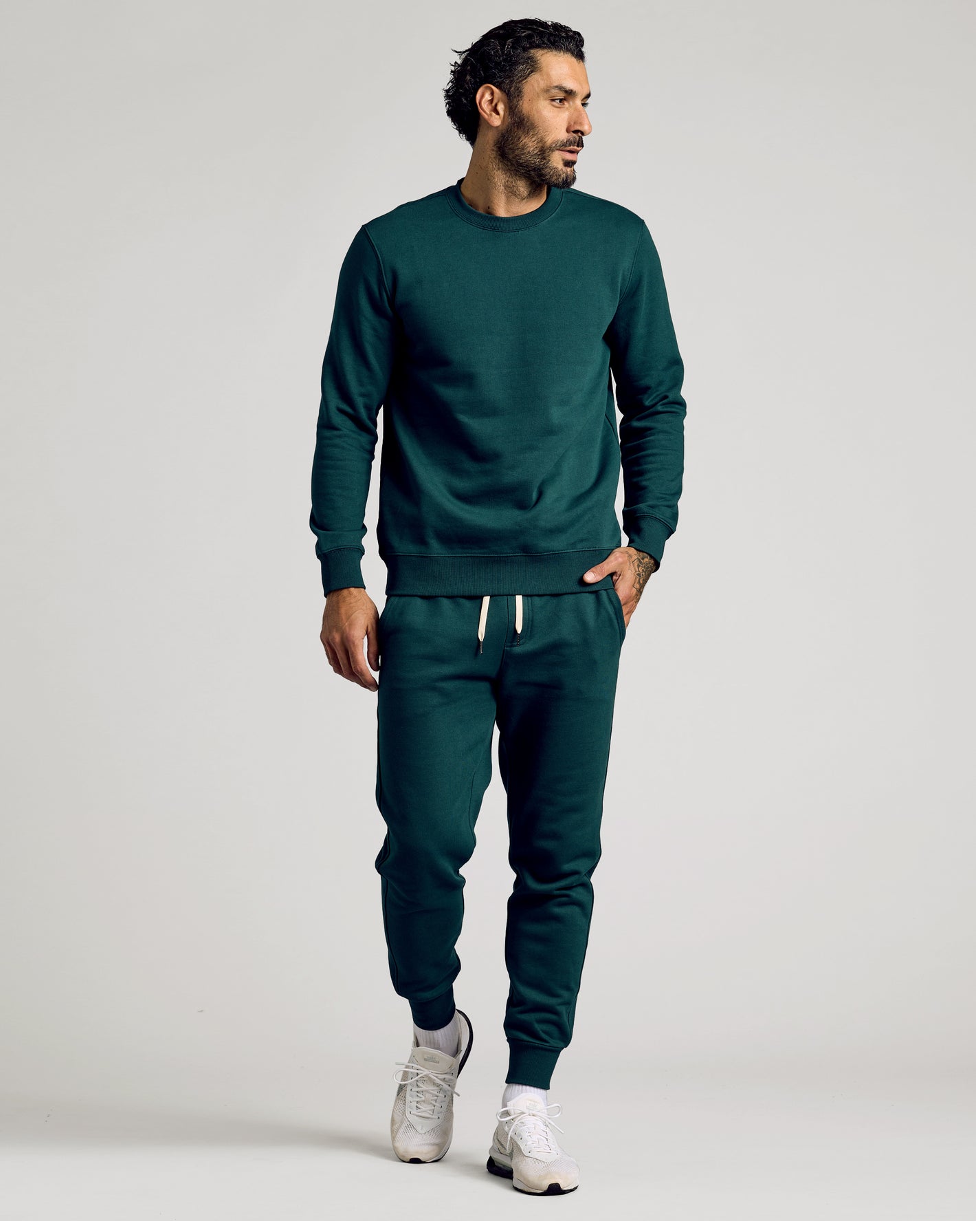 Man wearing Emerald Fleece French Terry Pullover Crew Neck Sweatshirt.