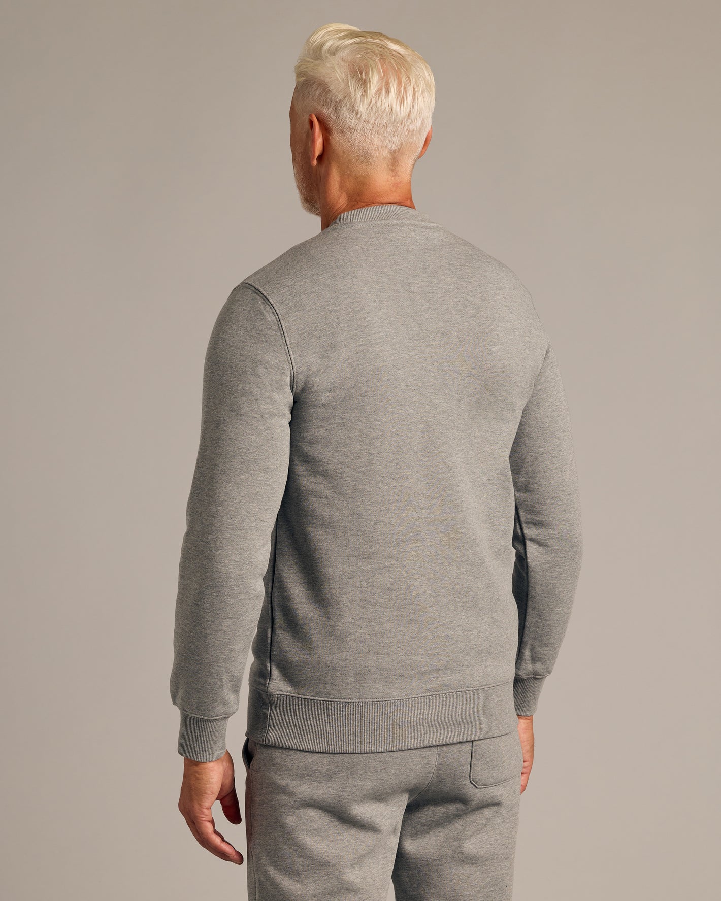 Person in back view wearing Dark Heather Gray Fleece French Terry Pullover Crew Neck.
